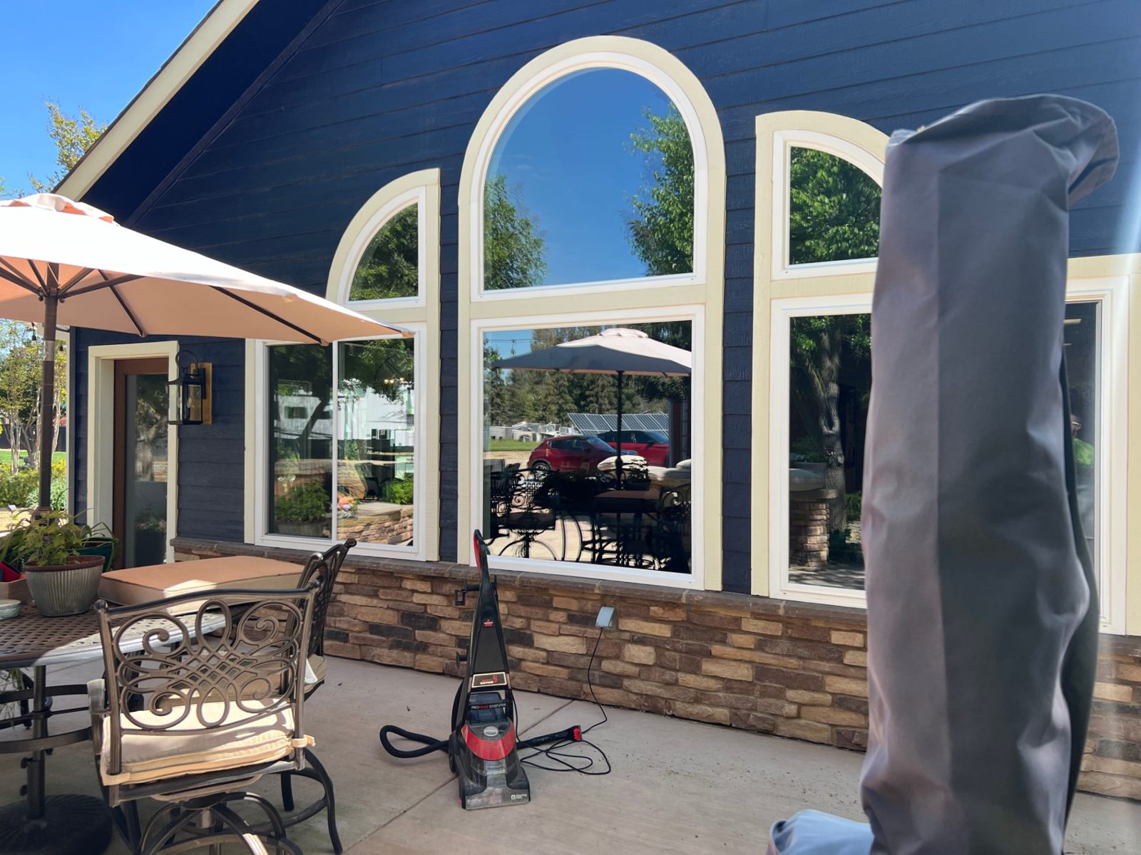 Arched rear windows on a Fresno home cleaned to spot-free glass by Primetime Services