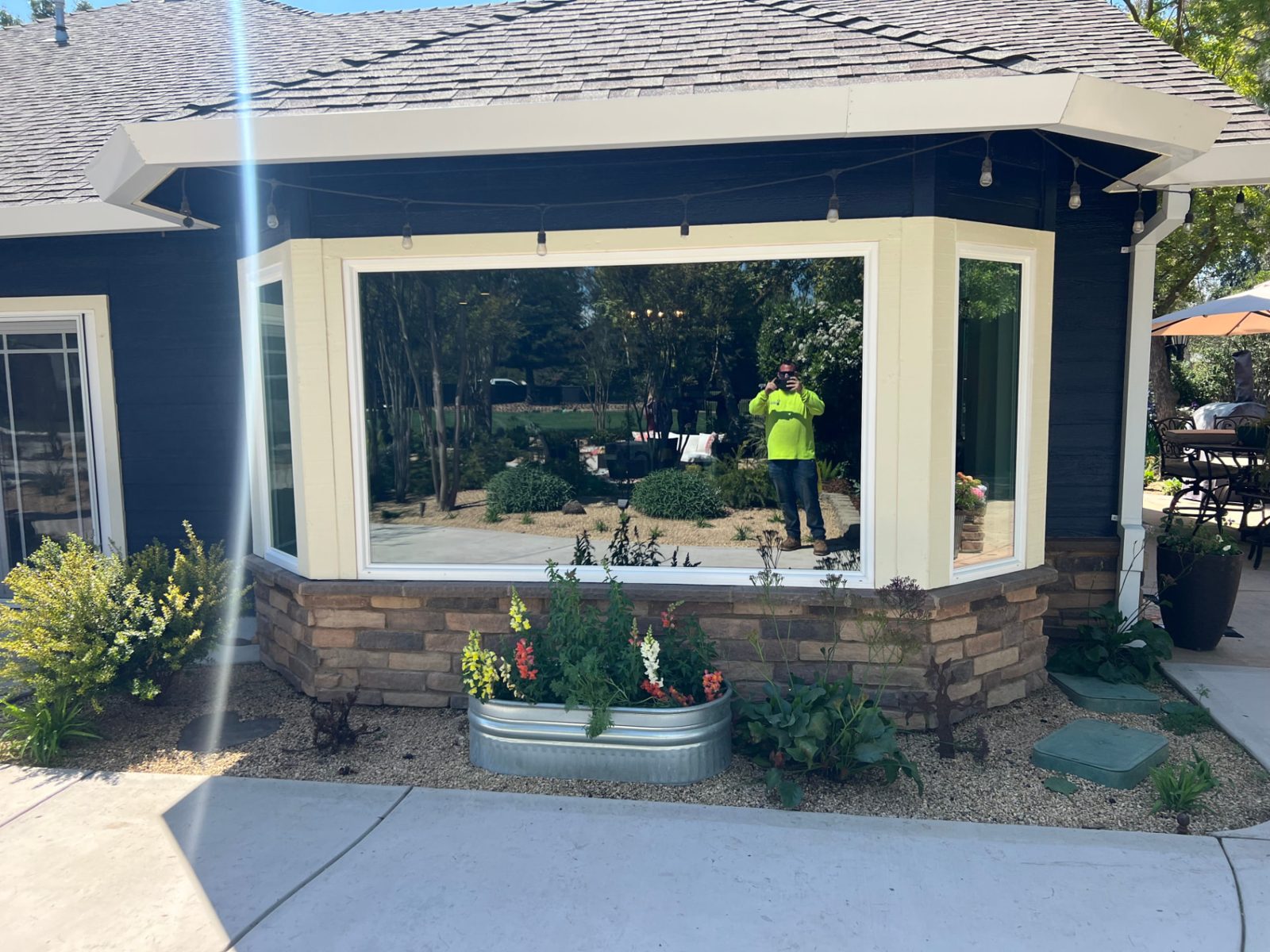 Mirror-clear picture window reflecting the yard after a Primetime window cleaning