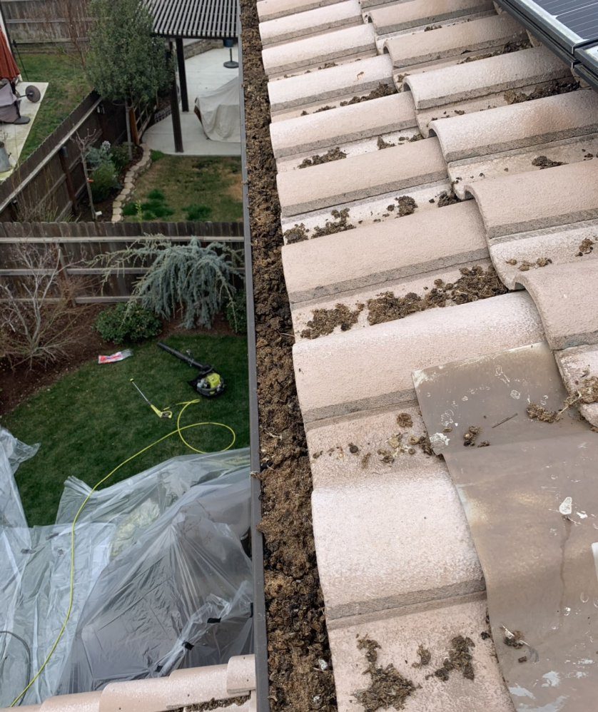 Rain gutter cleared of leaves and debris on a Fresno home