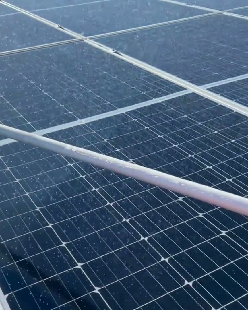 Purified water rinsing a Fresno rooftop solar array during a Primetime Services cleaning