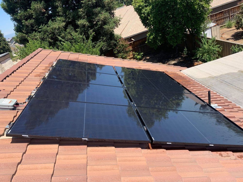Glossy clean solar panels on a red tile roof in Fresno